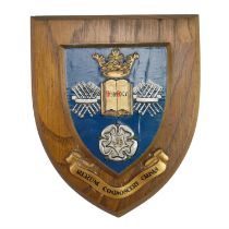 A University of Sheffield painted wood armorial wall plaque, third quarter 20th Century, 8 cm x 15