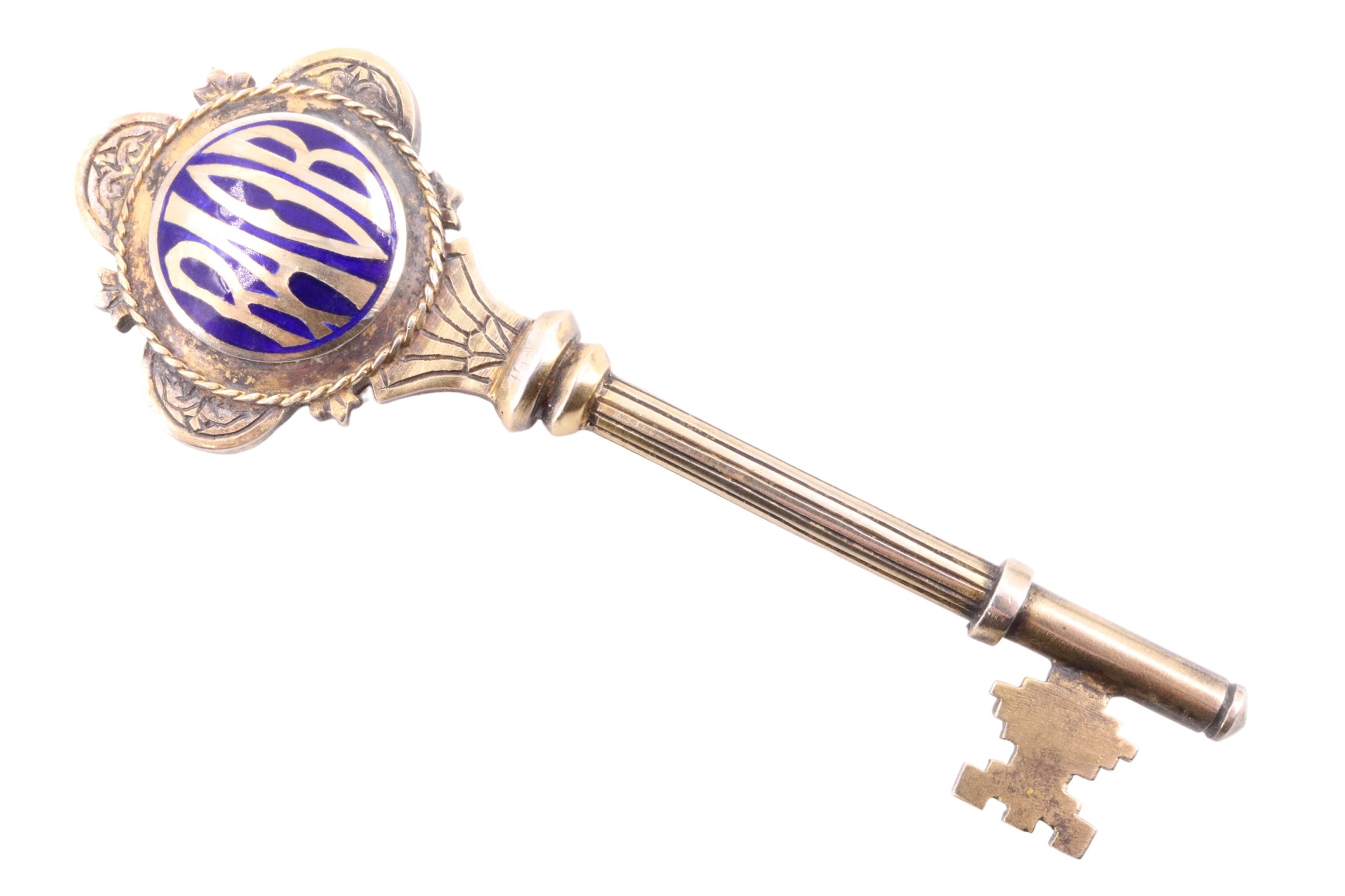 An enamelled gilt white-metal presentation key, engraved "Presented to Councillor J Blythe JP In