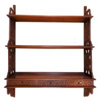 A reproduction George III Chippendale style waterfall hanging bookshelf, having drawers to the base,