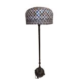 A contemporary patinated brass and leaded glass standard lamp, 158 cm including shade