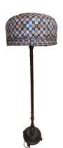 A contemporary patinated brass and leaded glass standard lamp, 158 cm including shade