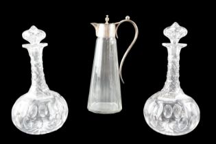 A pair of Victorian cut glass wine decanters, together with an electroplate mounted claret jug,