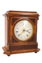An early 20th Century walnut mantle clock, having a brass drum movement with platform escapement and