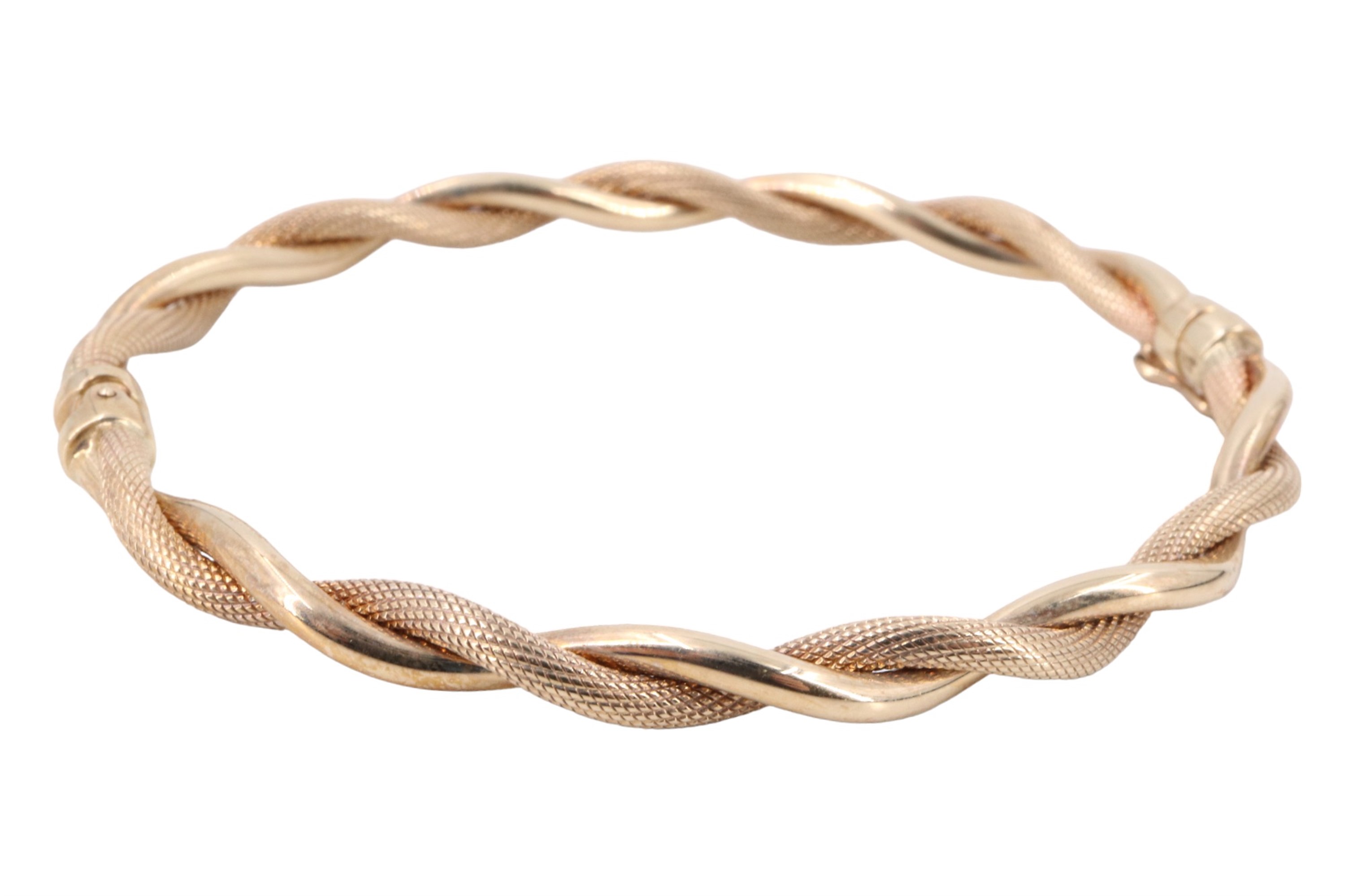 A contemporary Italian 9 ct gold cable bangle, having polished and textured twists, sprung hinge