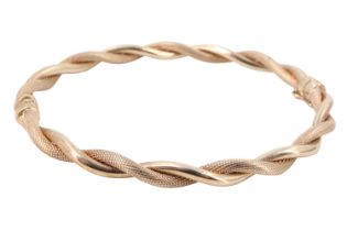 A contemporary Italian 9 ct gold cable bangle, having polished and textured twists, sprung hinge