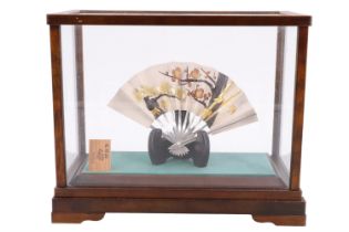 A Japanese ornamental white metal fan, stand and glazed case, 19 cm x 23 cm