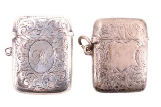 Two Edwardian silver vesta cases, both decorated with engraved foliate scrolls, one having an