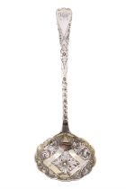 A Georgian silver Old English pattern caster / dredger spoon, having a parcel gilt pierced bowl