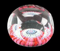 A Whitefriars glass cane cluster paperweight, of oblate form with printie facets