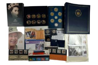 A quantity of royal commemorative coins and stamp covers, including a platinum one pound banknote, a