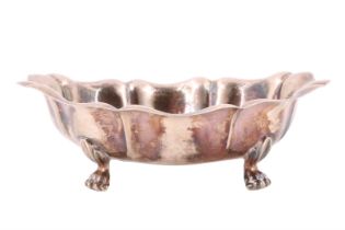 A mid-to-late 20th Century white metal bon-bon dish, having lobed sides raised on four feet,