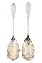 A pair of Victorian silver berry or similar spoons, the stems decorated with engraved blossom and