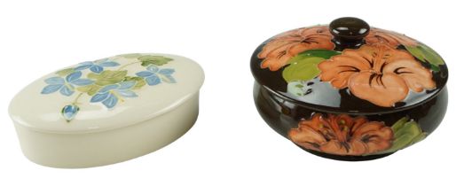 Two Moorcroft lidded boxes, (one having rim chip to lid)