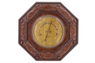 A John Barker & Co of Kensington oak aneroid barometer, 32 cm