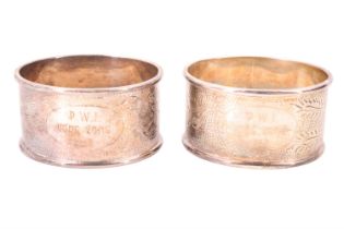 A pair of cased Chinese white metal napkin rings, variously engraved with a phoenix and a dragon,