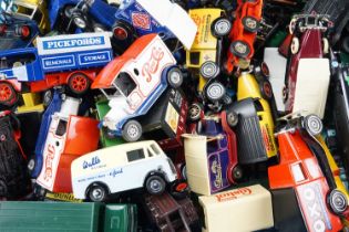 A quantity of loose and boxed diecast vehicles, mostly vintage delivery wagons