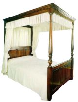 A king sized reproduction oak four poster bed