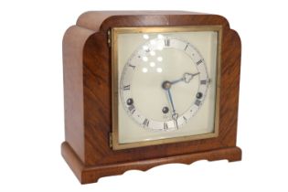 A 1930s Elliot walnut veneered mantle clock having a three train movement striking on rods, 22 cm