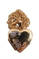 A 9 ct gold heart shaped double locket on fine curb link chain, having two tone engraved floral