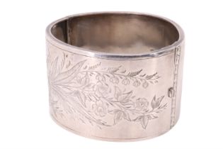 A Victorian silver bangle, decorated with engraved flora, James Fenton, Birmingham, 1885, 38 mm