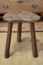 An oak three legged milking stool by Derek 'Lizardman' Slater of Crayke, North Yorkshire, 42 cm high