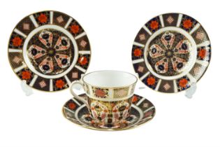 A Royal Crown Derby Imari trio and a further tea plate