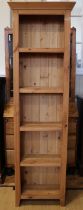 A contemporary pine tall and slender bookcase, 59 x 27 x 199 cm
