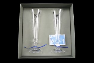 A pair of boxed Wedgwood glass champagne flutes, decorated with wheel-cut floral swags, 23 cm high