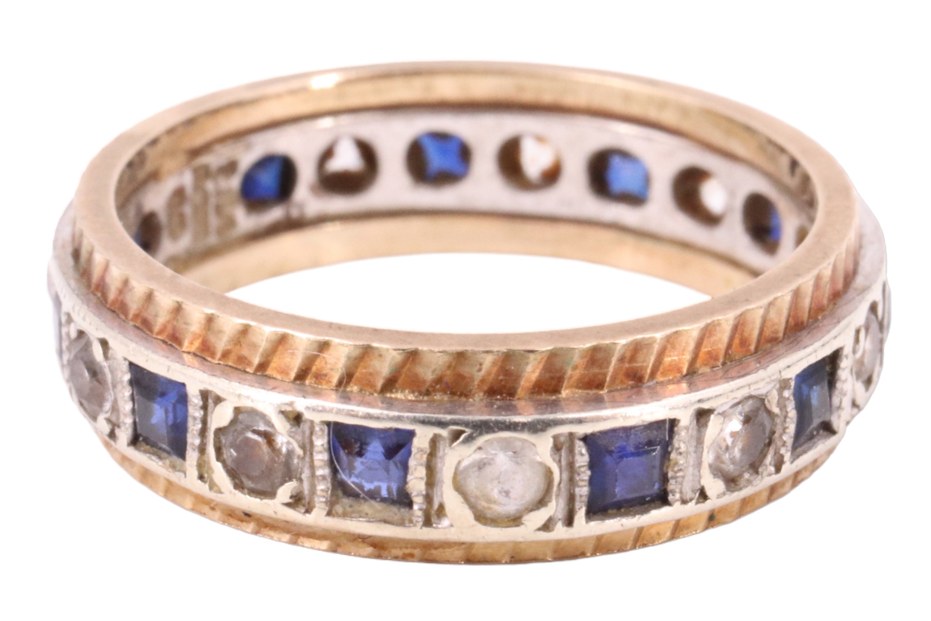A blue sapphire and white spinel eternity ring, having 11 2 mm square sapphires separated by 11 2 mm