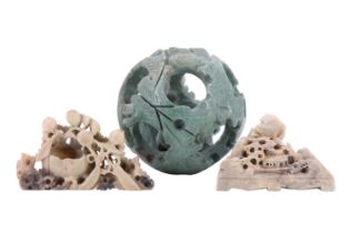 A carved soapstone puzzle ball, 9 cm high, together with two soapstone figurines