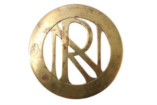 A large brass badge, being a monogram RN or NR within an annulus, a pair of lugs verso, 63 mm