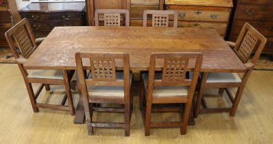 An adzed oak refectory dining table and six chairs by Derek 'Lizardman' Slater of Crayke, North York