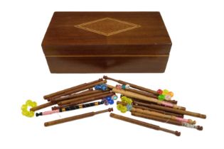 A group of lace making bobbins together with an inlaid mahogany box