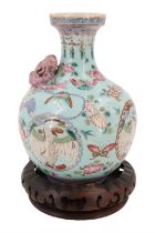 A Chinese blue-ground famille rose bottle vase, decorated with applied three clawed dragon and