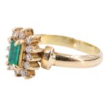 A late 20th Century emerald and white beryl finger ring, having an emerald baguette set on a