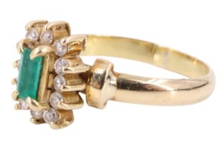 A late 20th Century emerald and white beryl finger ring, having an emerald baguette set on a