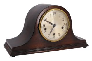 A Haller oak veneered "Napoleon Hat" mantle clock, having a three train movement striking on rods,