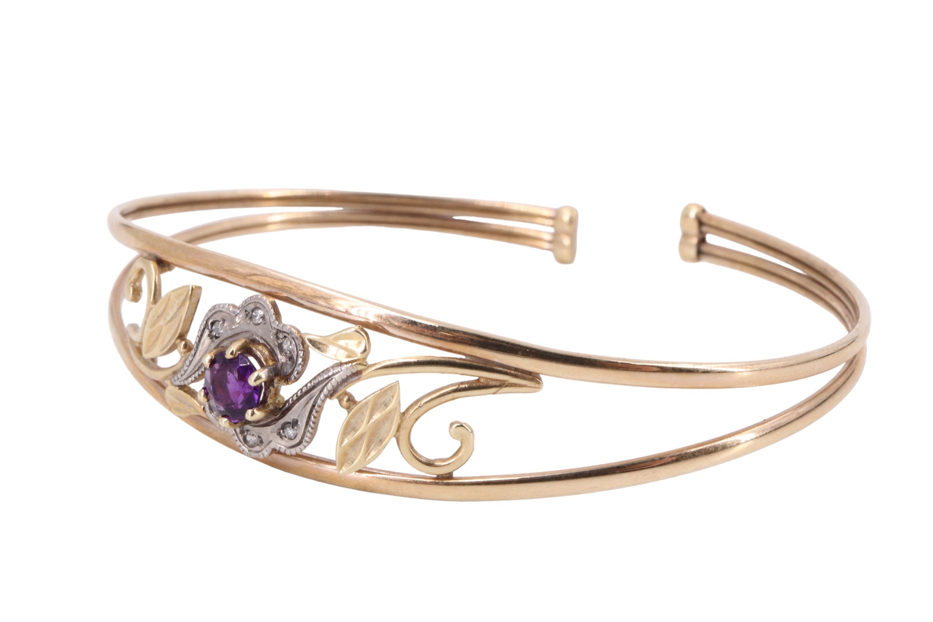 A contemporary amethyst and white stone set floral bangle, having a 5 mm amethyst brilliant