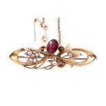 An Edwardian almandine, seed pearl and 9 ct gold floral sprig and scroll brooch, 42 mm, 3.4 g