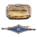 An Art Deco citrine brooch, having a 30 x 16 mm stone set in a canted white metal bezel, and an