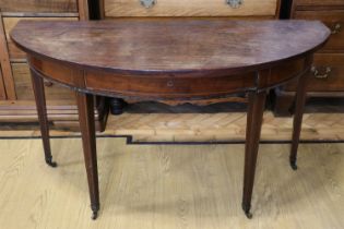 A George III mahogany string inlaid half-moon table, having a drawer in the frieze, 127 x 56 x 73