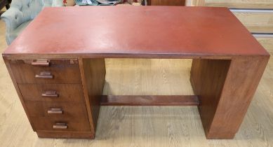 A 1930s walnut desk, one end having a draw slide and four drawers, opposed by an adjustable