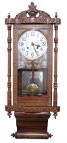 An early 20th Century American parquetry inlaid walnut wall clock, striking on a gong, later dial,