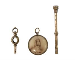 A Victorian rolled gold watch key, a gilt-metal propelling fob pencil, and a locket bearing Napoleon