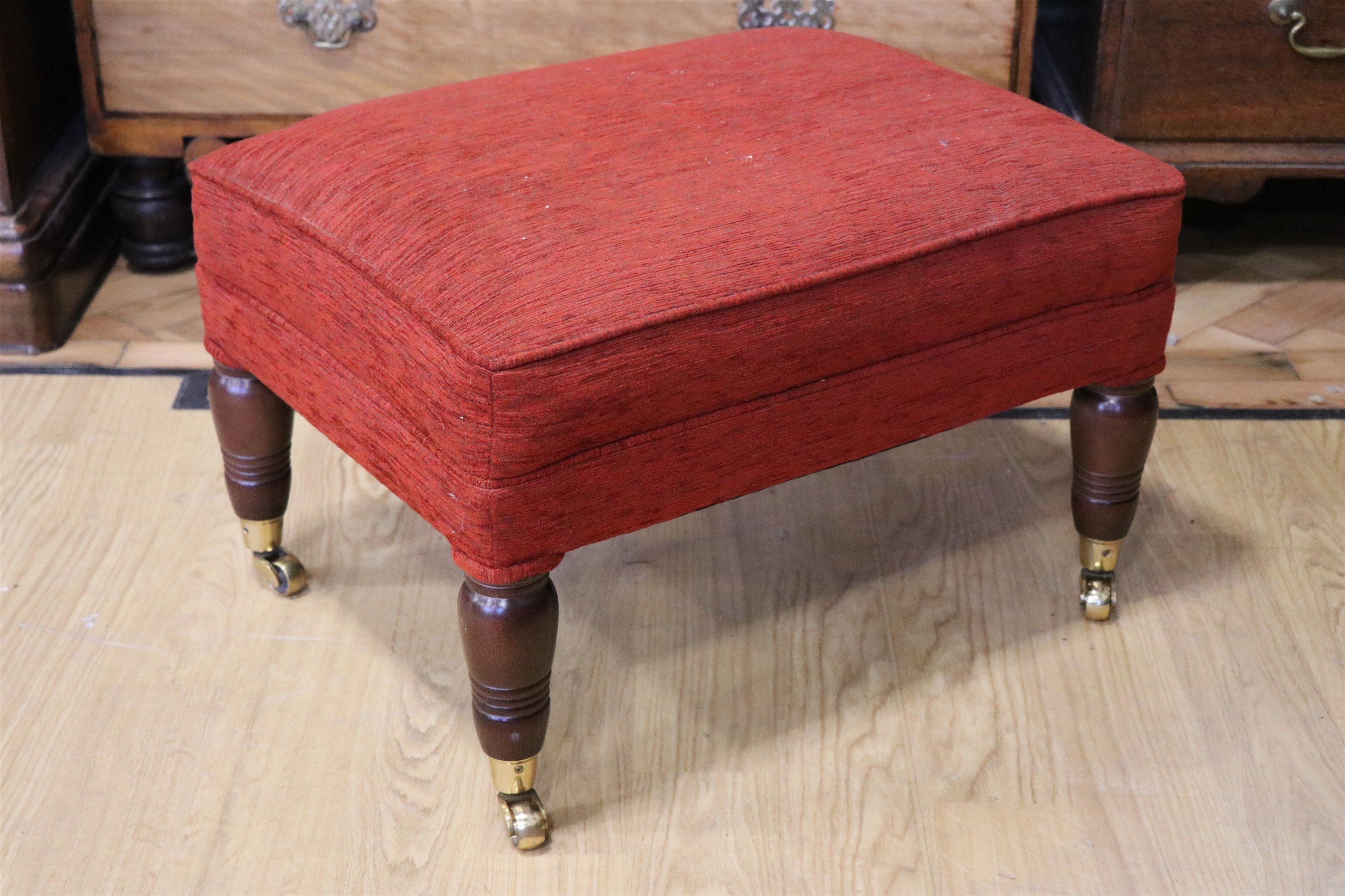 A contemporary upholstered footstool, having turned legs and brass cups and casters, 59 x 43 x 40 - Image 2 of 2
