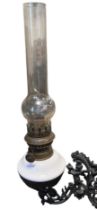 A Victorian oil lamp and cast iron wall bracket, 40 cm excluding bracket