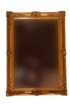 A contemporary bevel edged gilt framed mirror, 89 x 64 cm overall