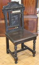 A late 19th / early 20th Century carved oak standard / hall chair