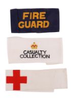 A Second World War Fire Guard printed brassard together with Red Cross and Civil Defence Casualty