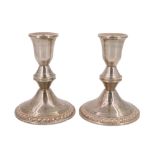 A pair of American Poole white-metal candlesticks, marked "Sterling Weighted", 11.5 cm
